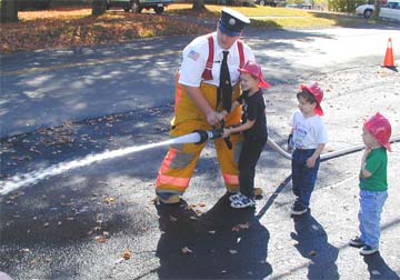 Image from Open House 2000 - Fireman demonstrating Hose